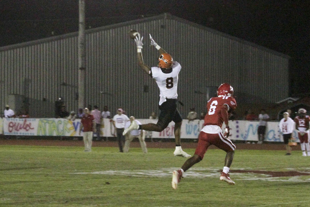 A man jumping in the air to catch a ball