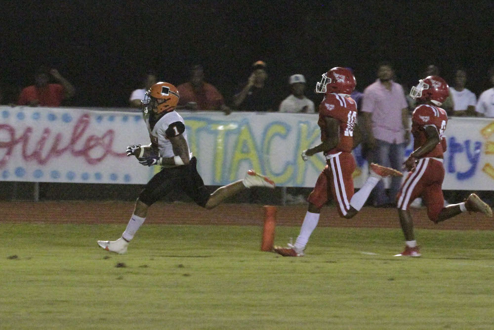 A football player running for the goal line.