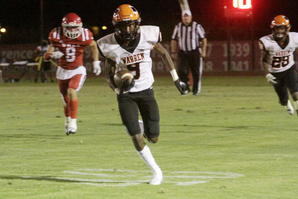 A football player running for the goal line.