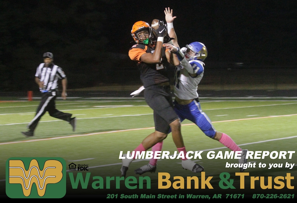 A football player is in the middle of an interception.