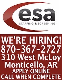 A red and white sign with the words " esa staffing & screening ".