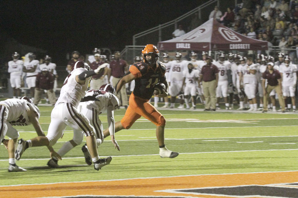 A football player running for the goal line.