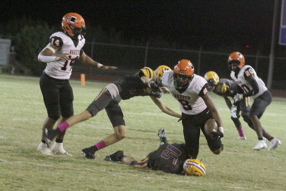 A group of people on the field playing football.