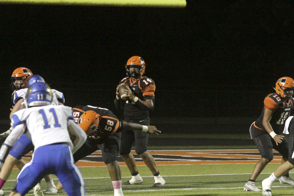 A football player is getting ready to throw the ball.