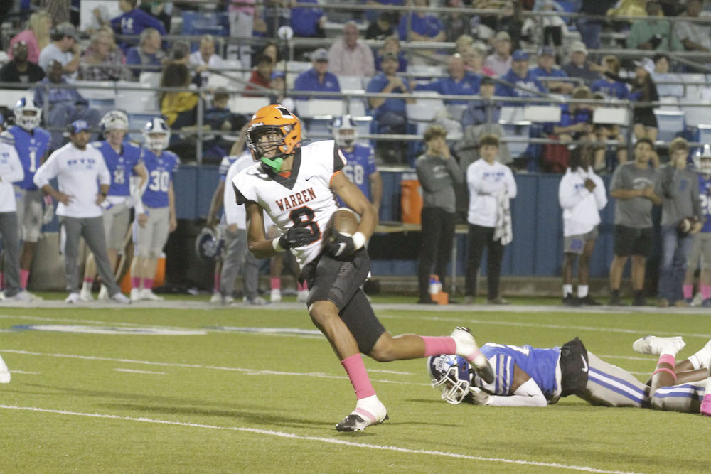 A football player running after the ball