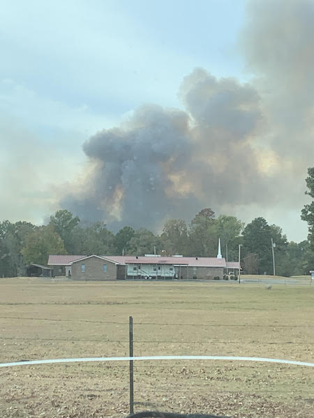 A large fire is burning in the distance.