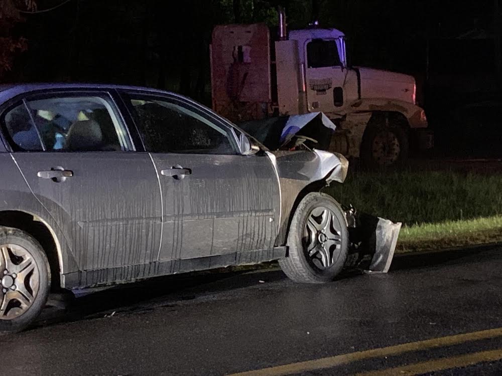 A car that has been hit by a truck.