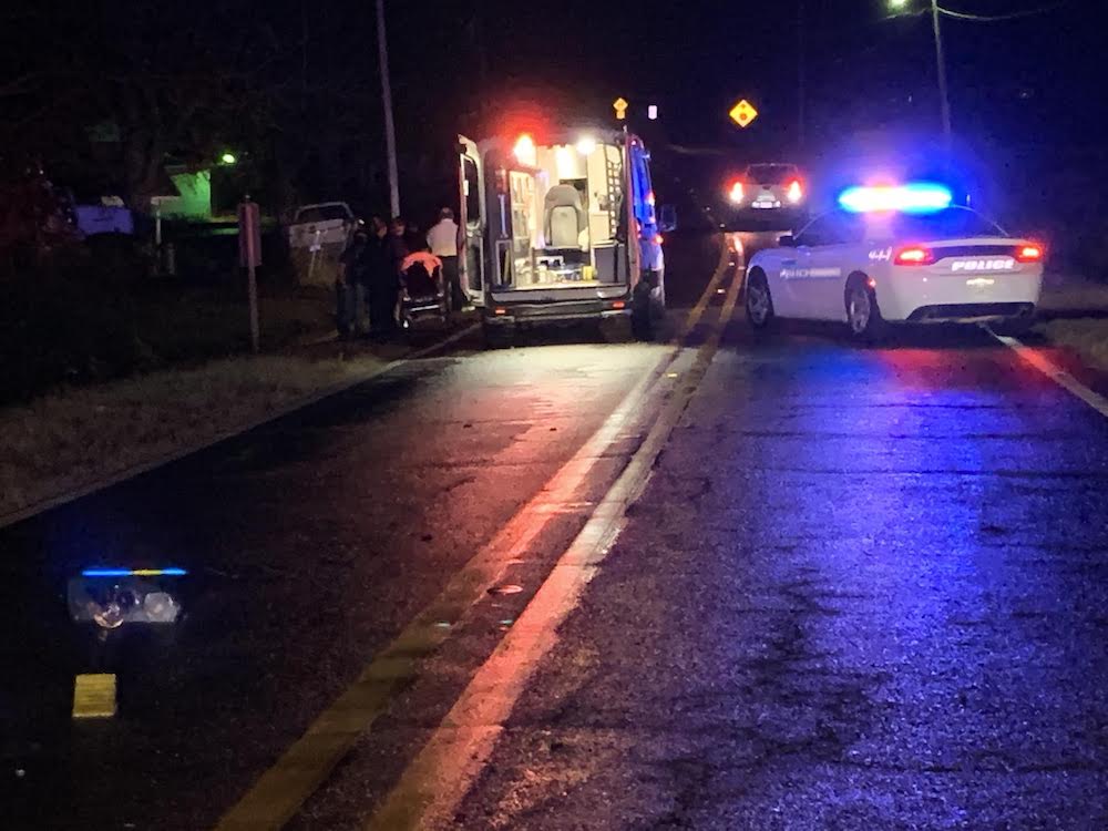 A police car and ambulance on the side of the road.