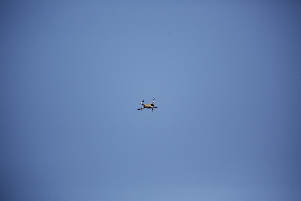 A small airplane flying in the sky on a clear day.