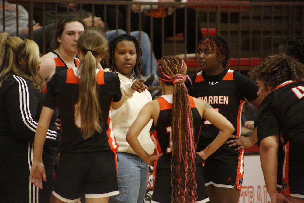 A group of women standing around each other.