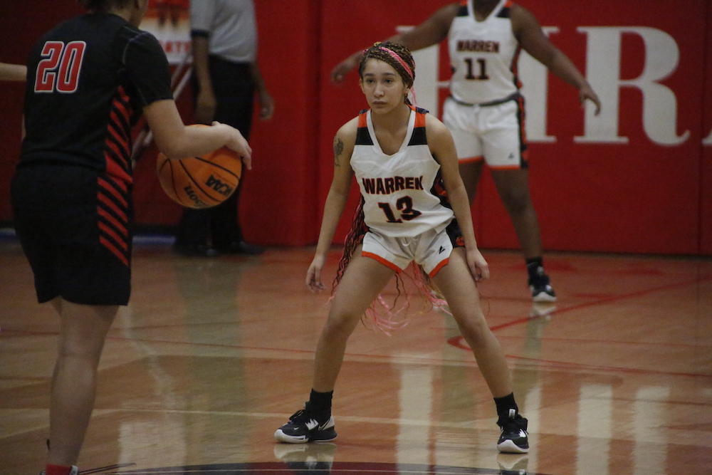 A girl is playing basketball on the court