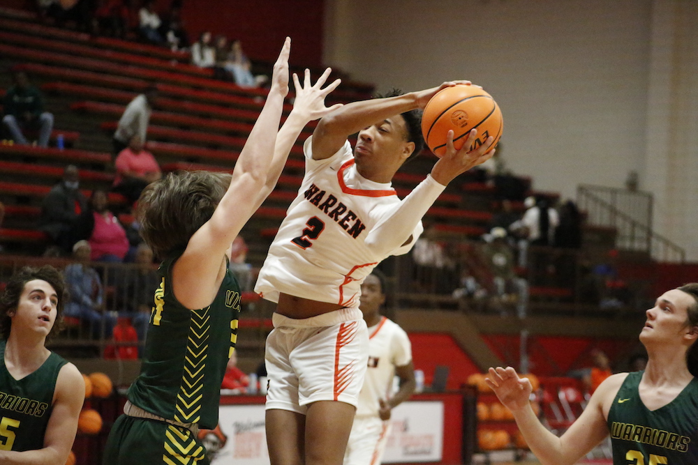 A basketball player is going to the basket.