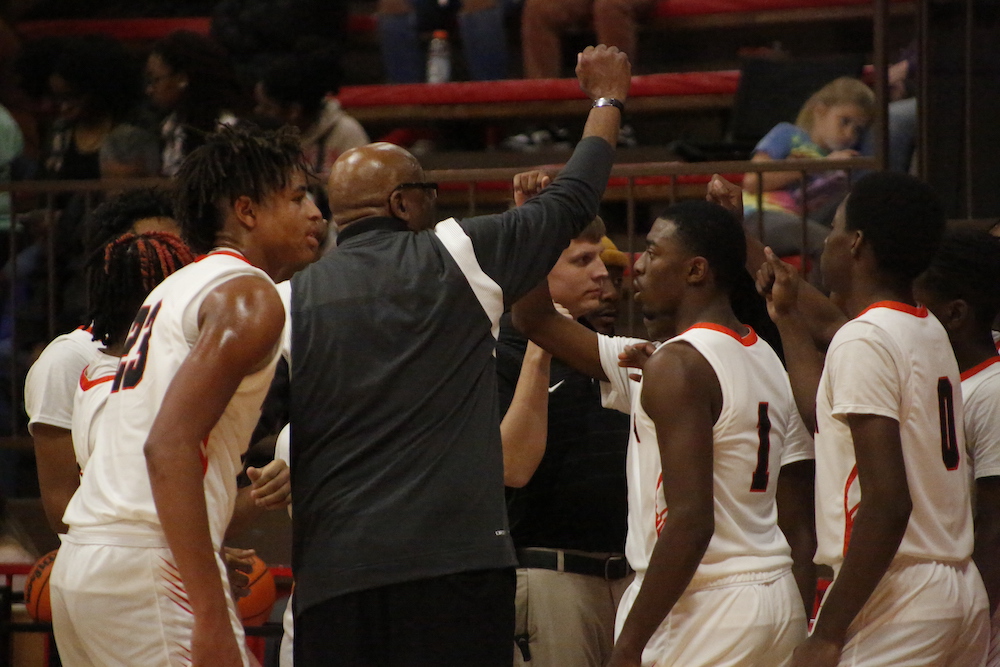 A group of men standing next to each other on a court.