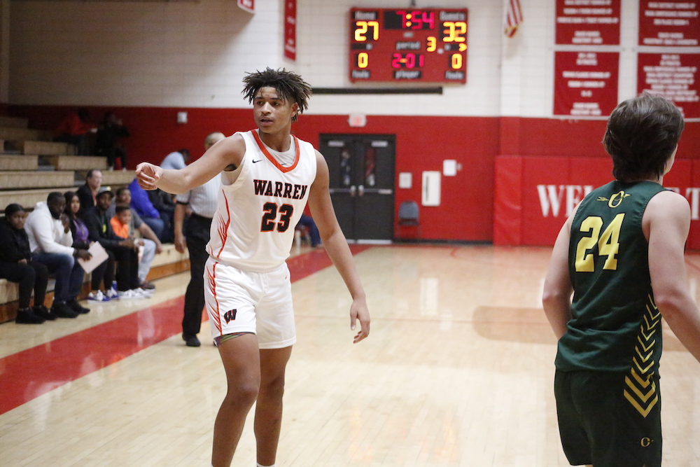A young man in white and red basketball uniform.