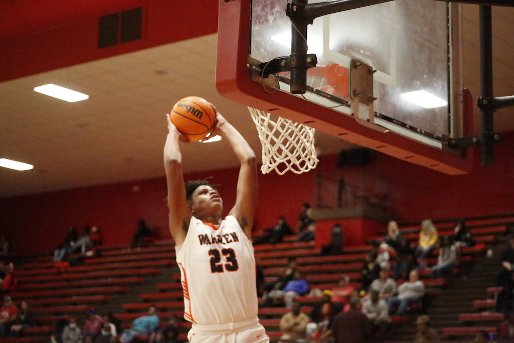 A man in white jersey holding a basketball.