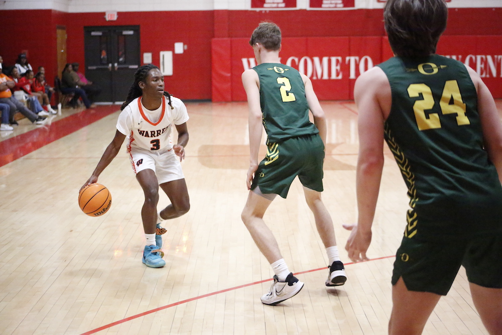 A group of young men playing basketball on a court.