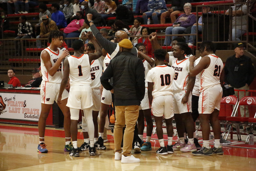 A group of men standing on top of a basketball court.