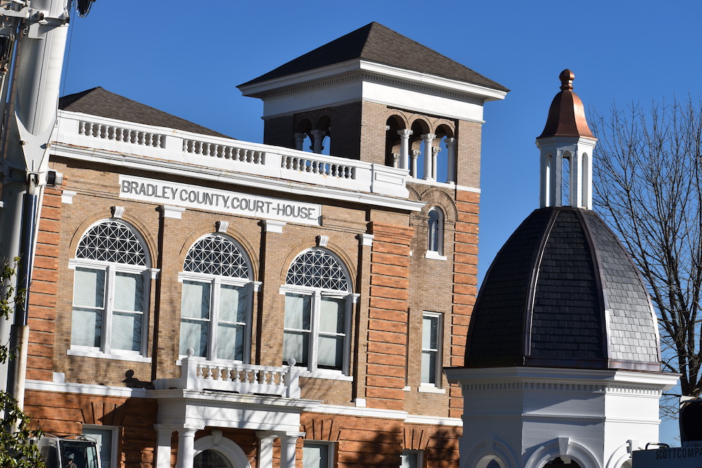 A building with a clock tower and a dome.
