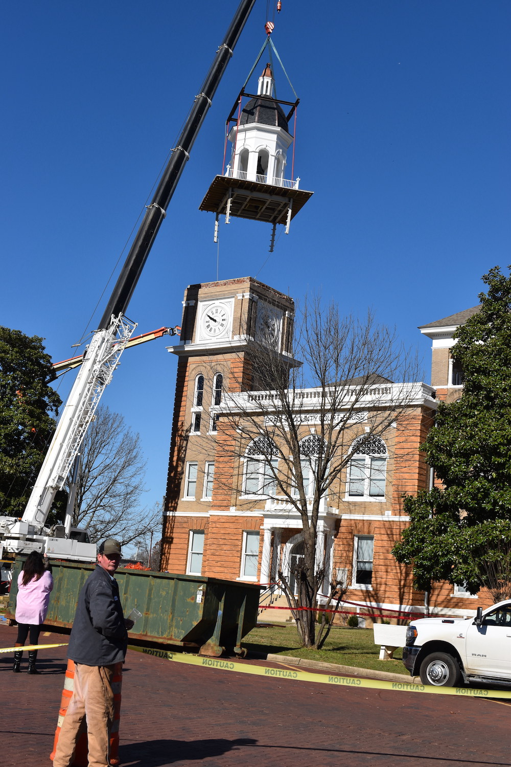 A crane is lifting up the clock tower.