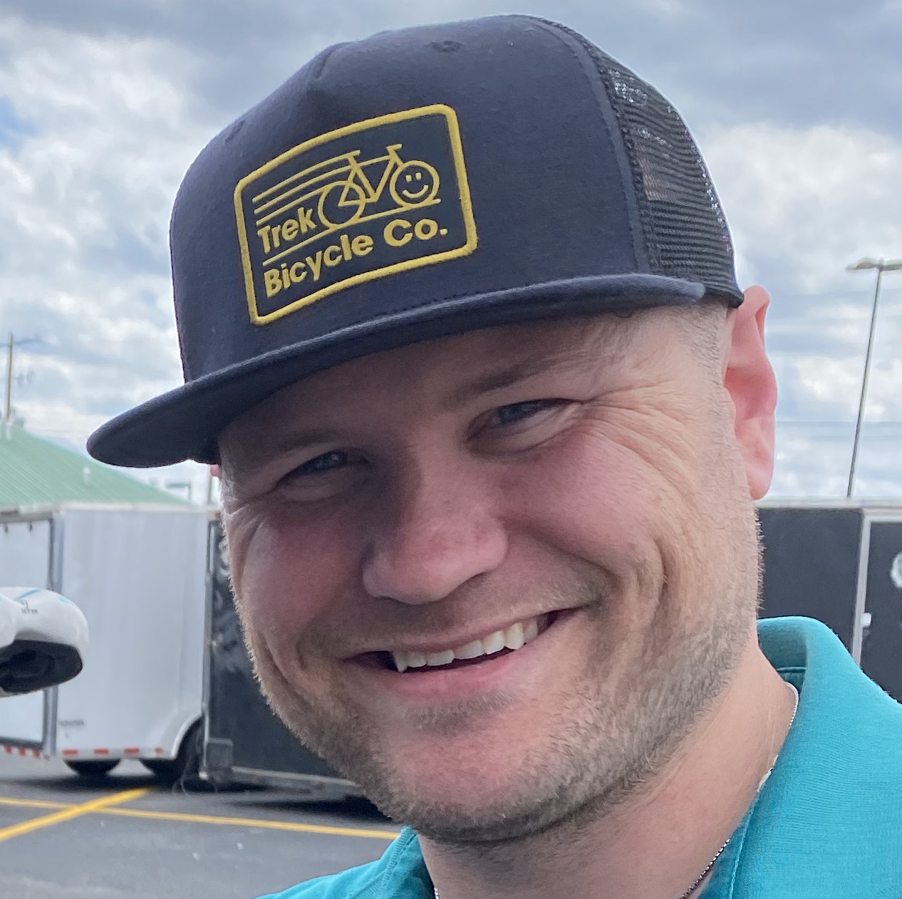 A man wearing a hat and smiling for the camera.