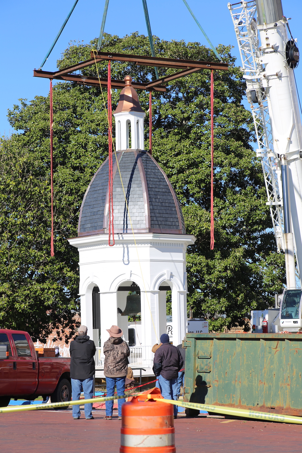 A group of people standing around a building.