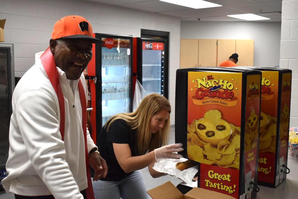 A man and woman looking at a box of cookies.