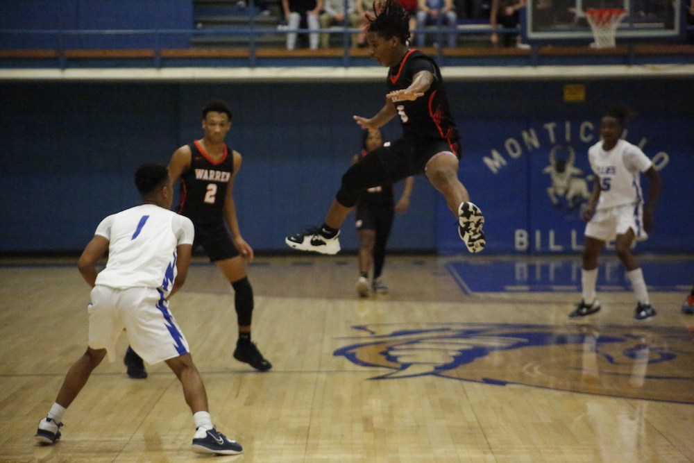 A group of men playing basketball on a court.