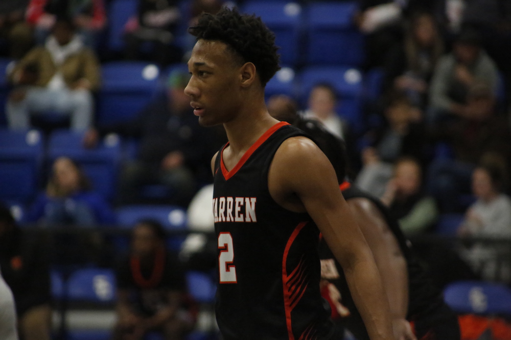 A basketball player is walking on the court.