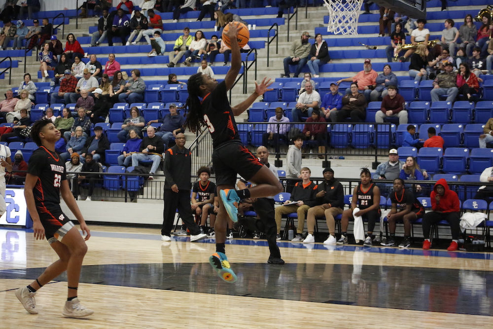 A person jumping in the air with a basketball