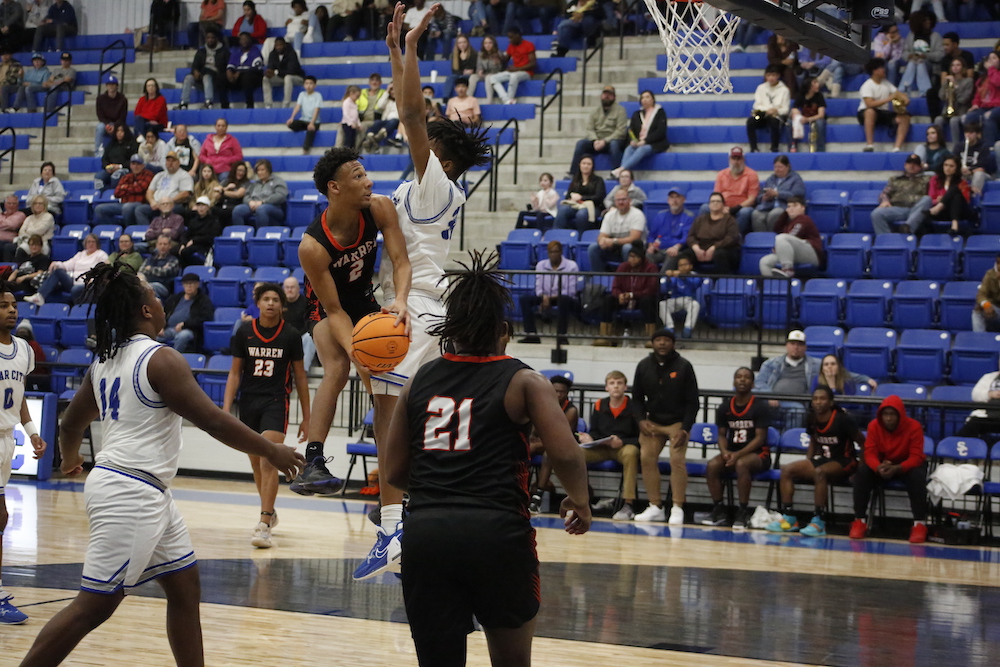 A basketball player is jumping to hit the ball.