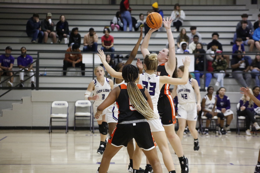 A group of girls playing basketball on the court