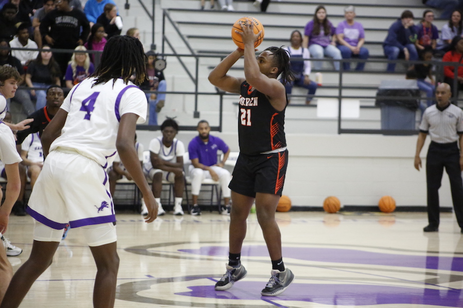 A person holding a basketball in the air