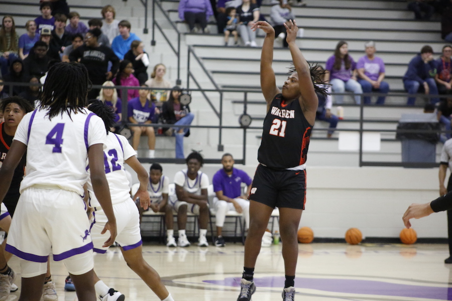A basketball player is about to hit the ball.