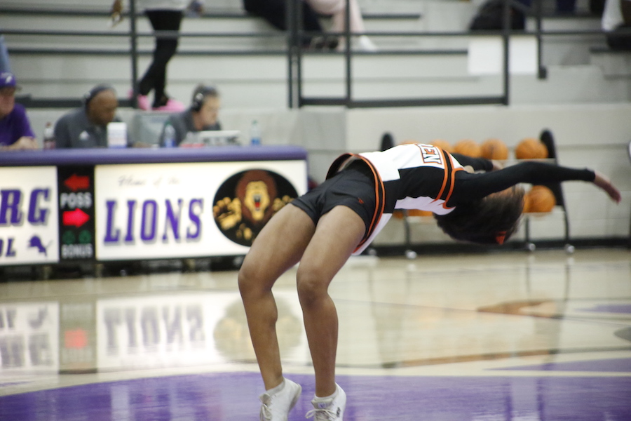 A person doing a handstand on the court