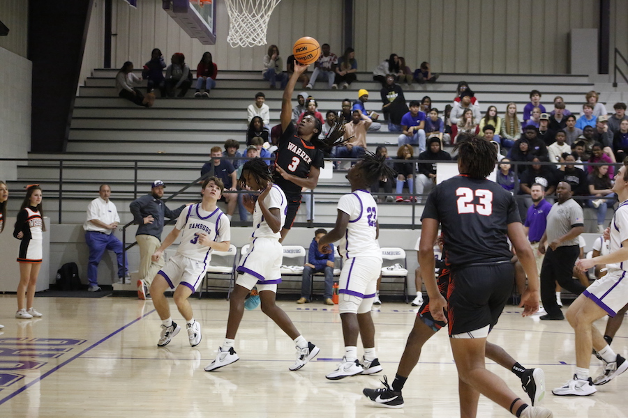 A group of men playing basketball on a court.