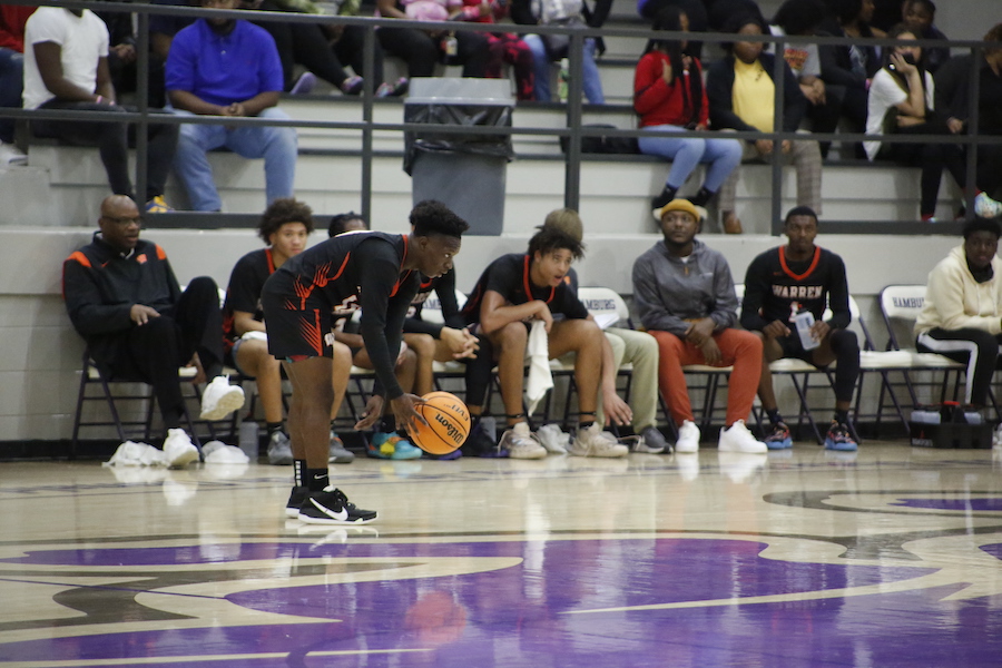 A group of people watching some basketball players