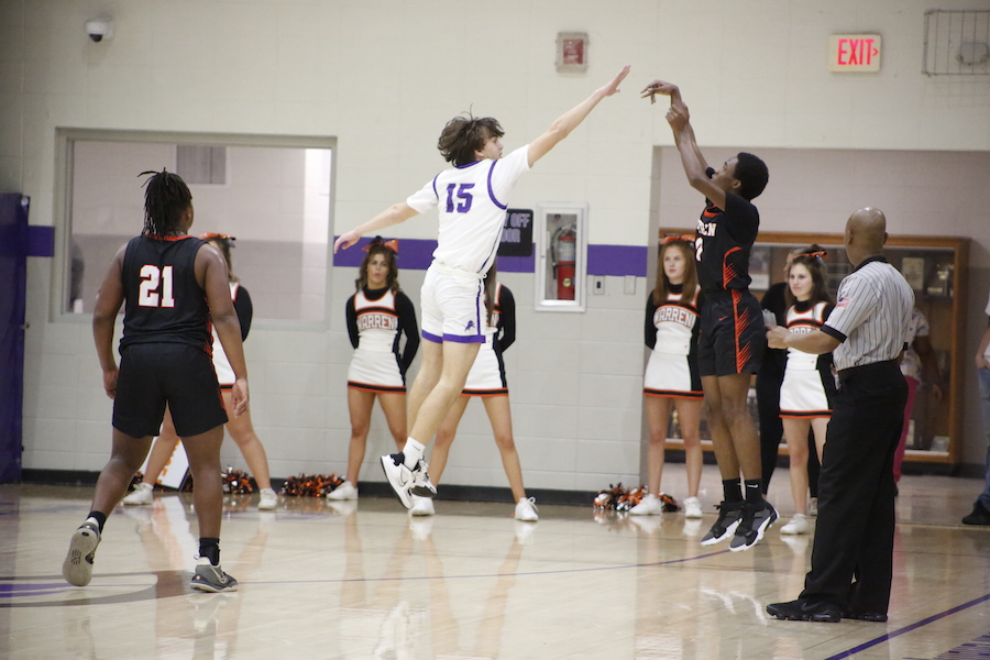 A group of young people playing basketball on a court.
