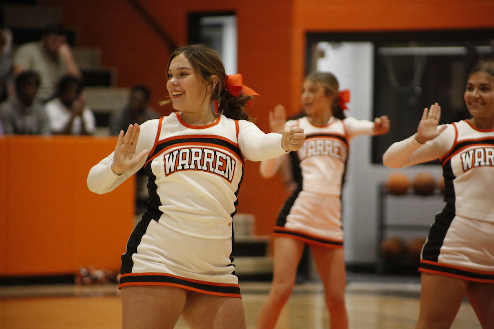 A group of young girls in cheerleader outfits.