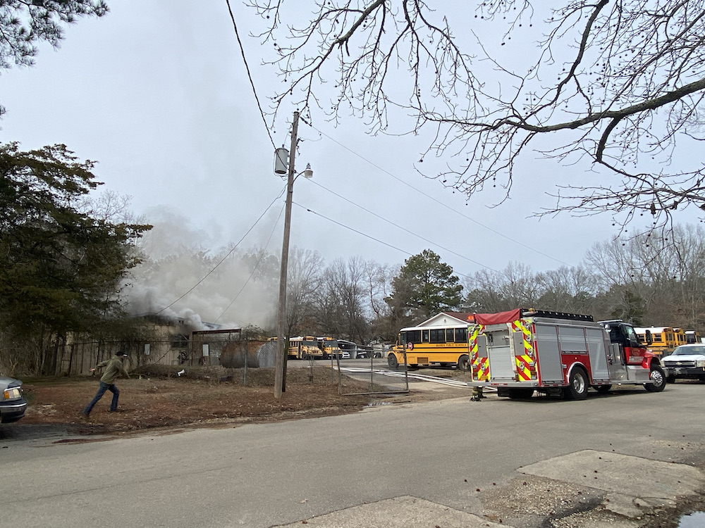A fire truck is parked in front of a house.