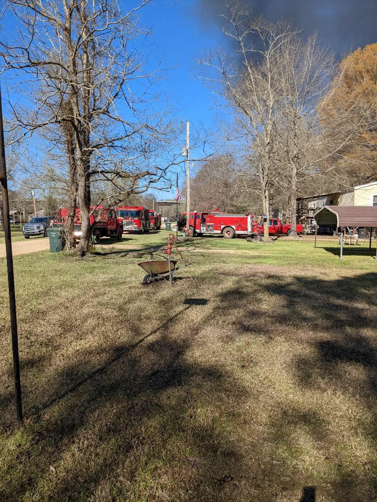 A fire truck parked in the middle of a field.