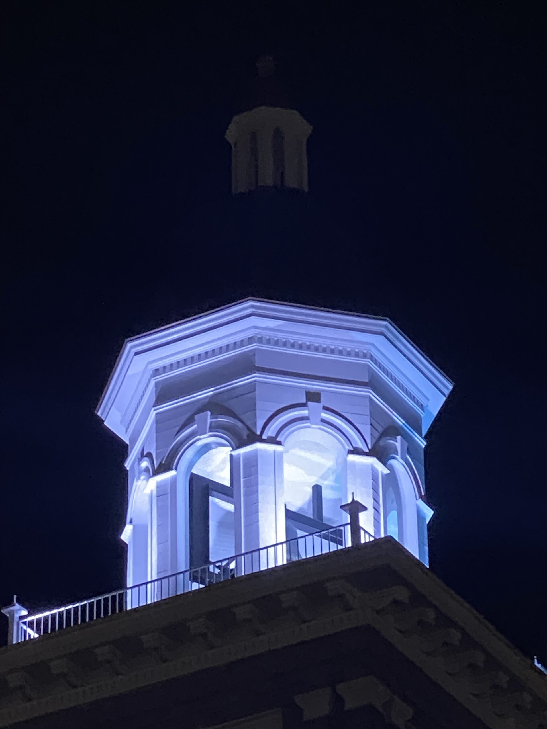 A building with blue lights on it's top.