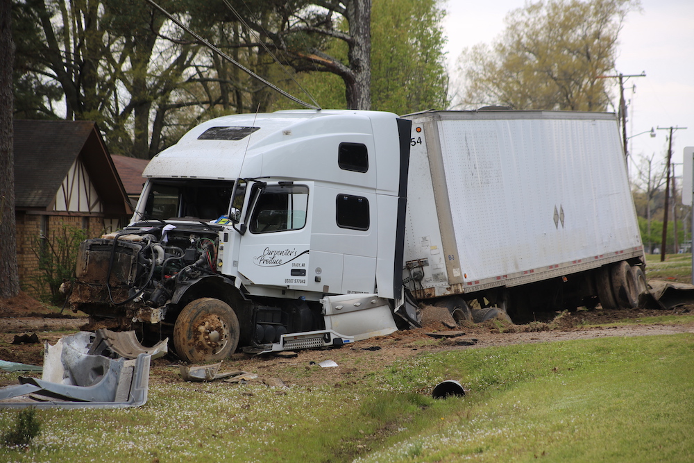 A white truck that has been hit by a car.