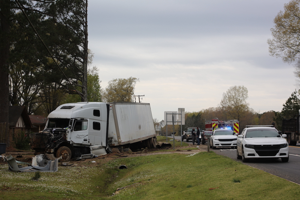 A white truck is on the side of the road