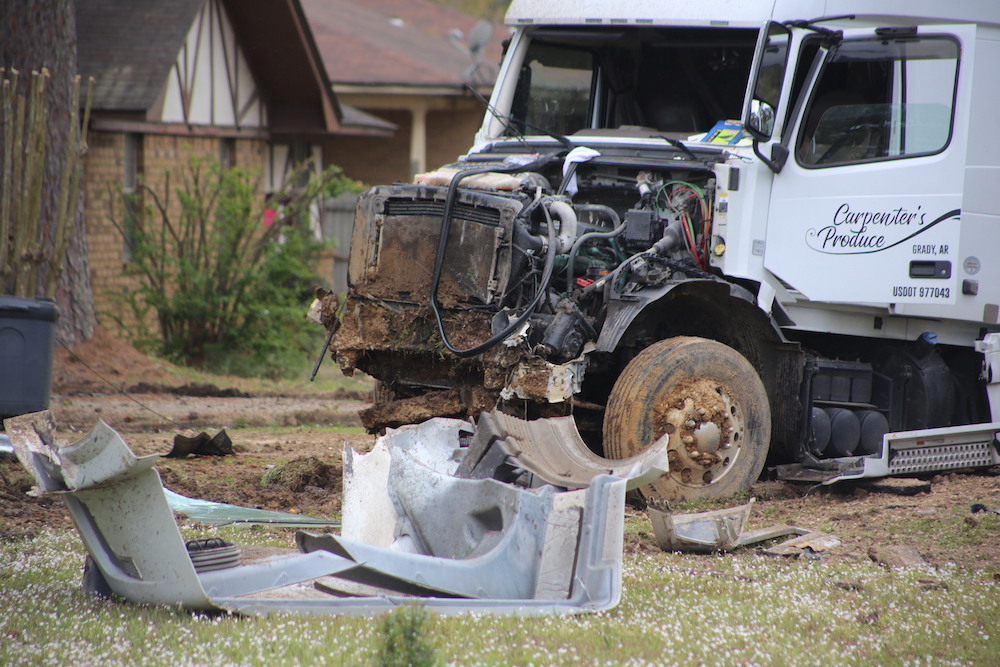 A white truck that is sitting in the grass.