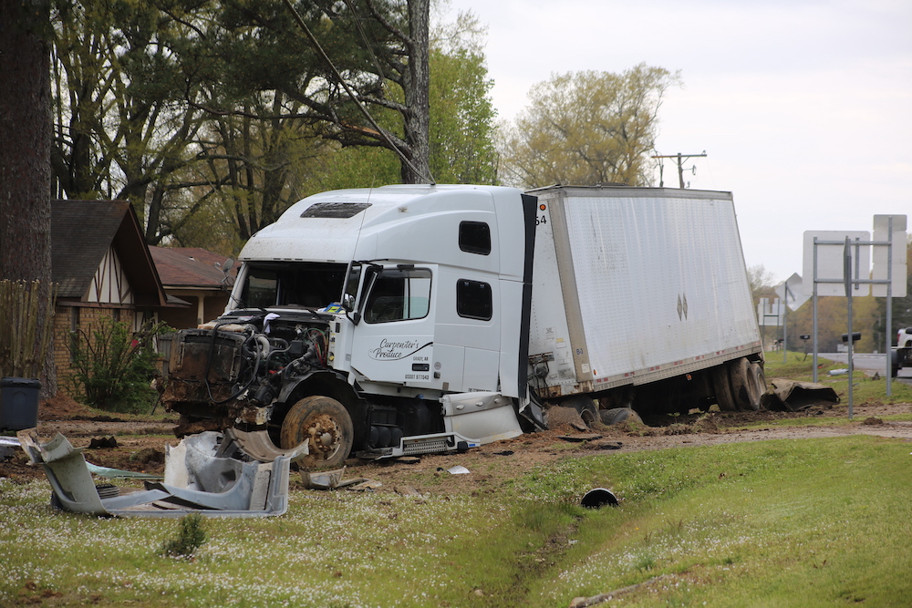 A white truck that has been hit by a car.