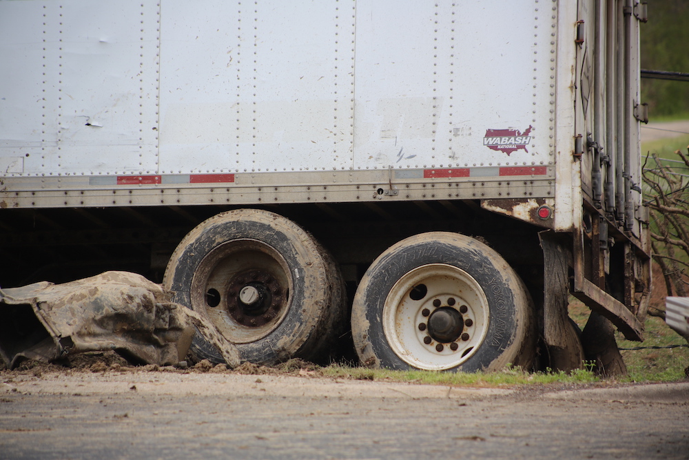 A truck that has been hit by a car.