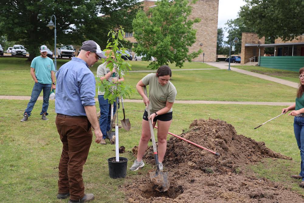A man and woman digging in the ground