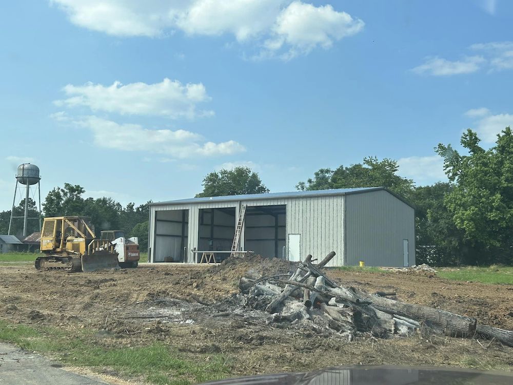 A building that is being built on the side of a road.