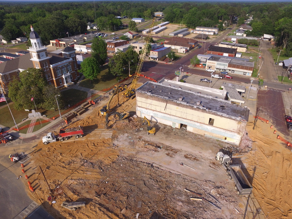 A large building being built in the middle of a town.