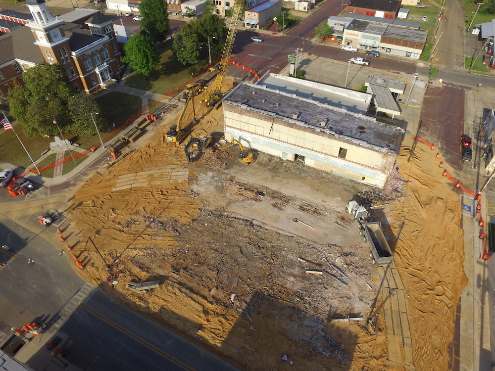 A construction site with many buildings and trees.
